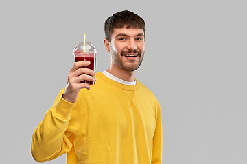 Image showing happy man with tomato juice in takeaway cup