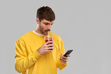 Image showing man with smartphone and tomato juice