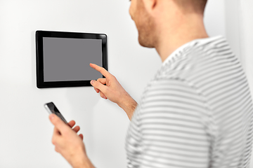 Image showing man with smartphone and tablet pc at smart home