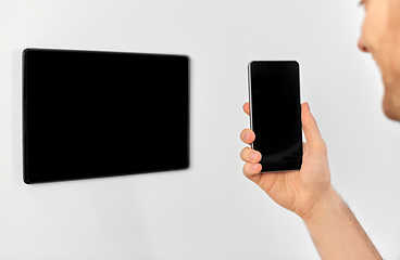 Image showing man with smartphone and tablet pc at smart home