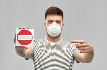 Image showing man in respirator mask showing stop sign