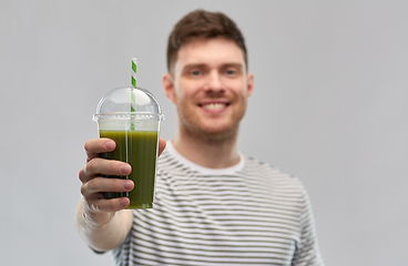 Image showing man drinking green smoothie from disposable cup