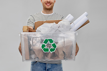 Image showing smiling young man sorting paper waste