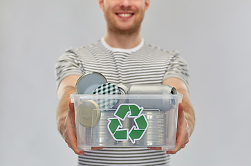 Image showing smiling young man sorting metallic waste