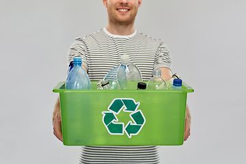 Image showing smiling young man sorting plastic waste