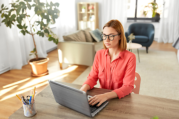 Image showing woman with laptop working at home office