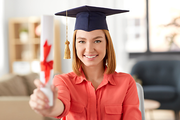 Image showing graduate student woman with diploma at home