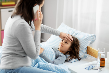 Image showing ill daughter and mother calling on phone at home