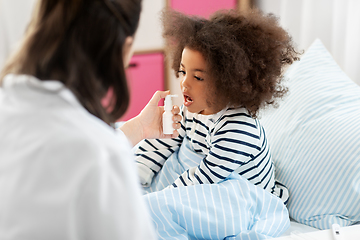 Image showing doctor with medicine treats sick girl at home