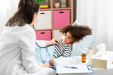 Image showing doctor with stethoscope and sick girl in bed