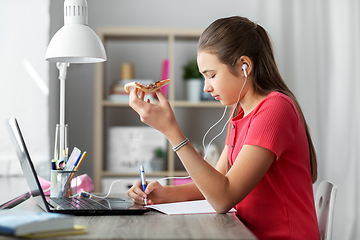 Image showing student girl in earphones with pizza at home