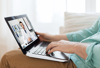 Image showing man having video call with male doctor on laptop