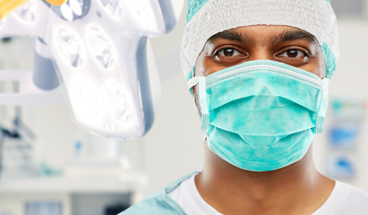 Image showing indian male surgeon in mask over operating room