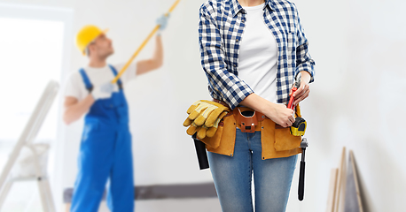 Image showing woman or builder with working tools on belt