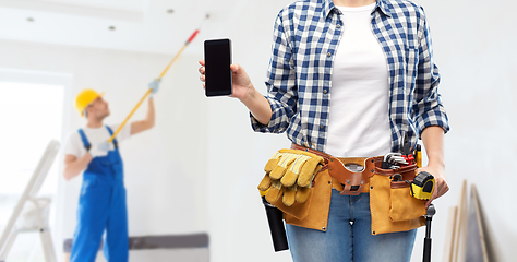 Image showing woman or builder with phone and working tools