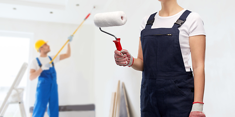 Image showing close up of painter or builder with paint roller