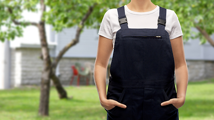 Image showing close up of female gardener or builder in overall