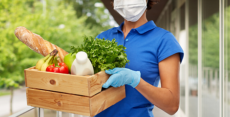 Image showing delivery woman in face mask with food in box