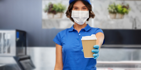 Image showing saleswoman in face mask with takeaway coffee cup