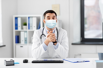 Image showing male doctor having video conference at hospital