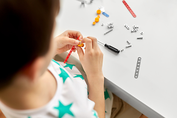 Image showing little boy playing with airplane toy at home