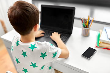 Image showing student boy typing on laptop computer at home