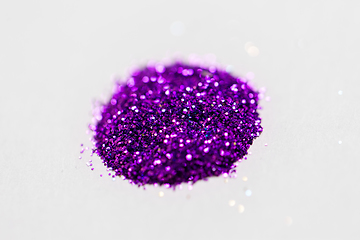 Image showing violet glitters on white background