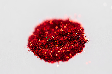 Image showing red glitters on white background