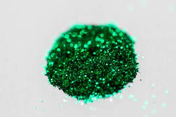 Image showing green glitters on white background