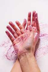 Image showing hands with glitters on white background