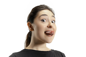 Image showing Smiling girl opening her mouth and showing the long big giant tongue isolated on white background, crazy and attracted