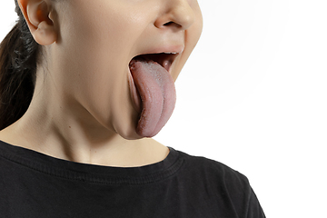 Image showing Smiling girl opening her mouth and showing the long big giant tongue isolated on white background, crazy and attracted