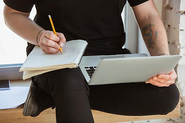 Image showing Young man studying at home during online courses for engineers, doctors, ecologists