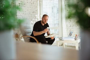 Image showing Young man studying at home during online courses for managers, marketers, buyers