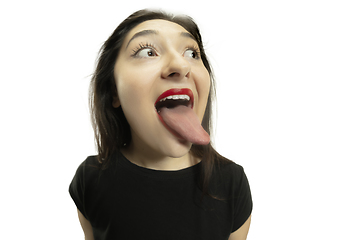 Image showing Smiling girl opening her mouth with red lips and showing the long big giant tongue isolated on white background, crazy and attracted
