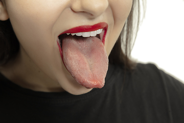 Image showing Smiling girl opening her mouth with red lips and showing the long big giant tongue isolated on white background, crazy and attracted, close up