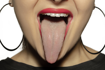 Image showing Smiling girl opening her mouth with red lips and showing the long big giant tongue isolated on white background, crazy and attracted, close up