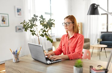 Image showing woman with laptop working at home office