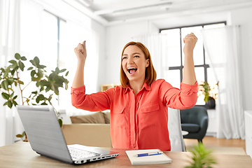 Image showing happy woman with laptop working at home office