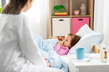 Image showing doctor and sick little girl in bed at home
