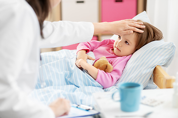 Image showing doctor measuring sick girl's temperature at home