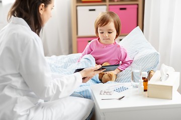 Image showing doctor with tablet computer and sick girl in bed