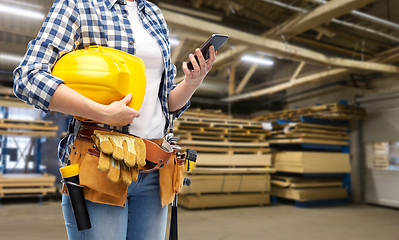 Image showing female worker with phone and tools at factory