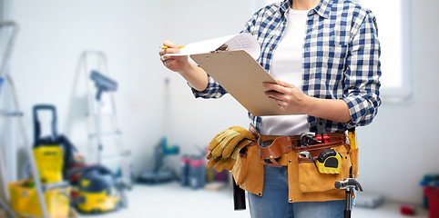 Image showing woman with clipboard, pencil and working tools