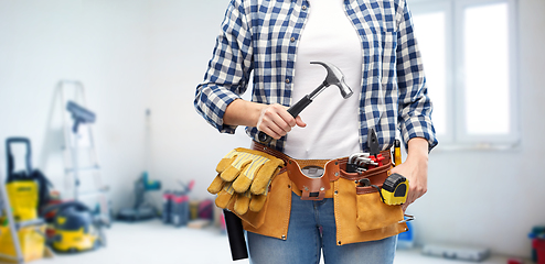 Image showing woman with hammer and working tools on belt