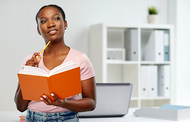 Image showing african american woman with notebook at office