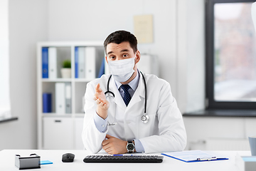 Image showing male doctor having video conference at hospital