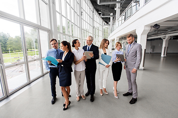 Image showing business team with tablet pc and folders at office