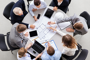 Image showing architects with laptop and blueprint at office