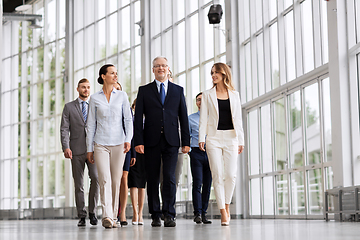 Image showing business people walking along office building